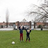 N8C1114+17 Thomas & Oliver jumping in front of Woodlands Park gates